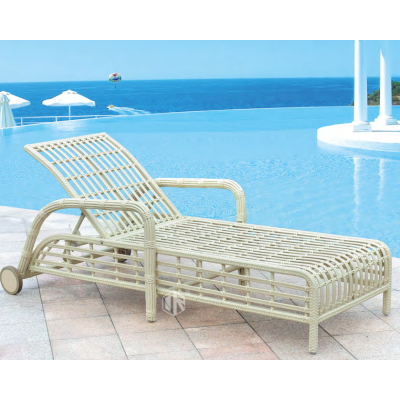 Rattan sun lounger chaise chair in beach/garden